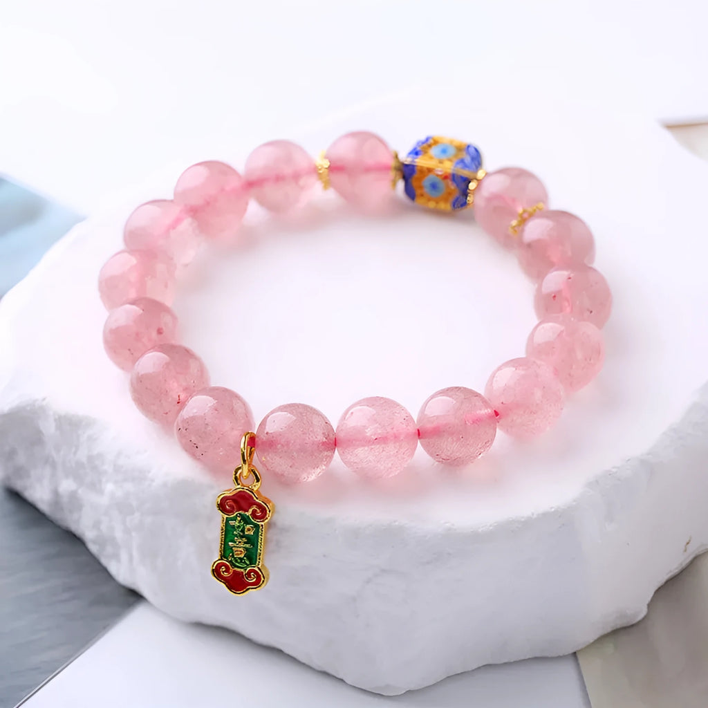 Pink crystal bracelet with hand-woven design featuring Ruyi charm and text elements
