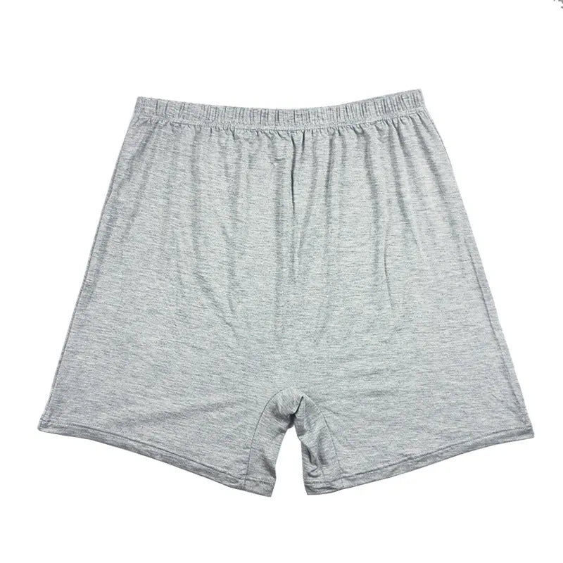 Man wearing solid colour high waist modal boxer shorts in a neutral shade.