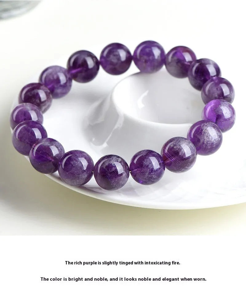 Snow Mountain Feather Amethyst crystal bracelet with scattered geometry beads and Ruyi design on a wrist.