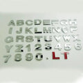 3D metal zinc alloy car letter sticker in black or silver, shown actual size at 2.5cm.