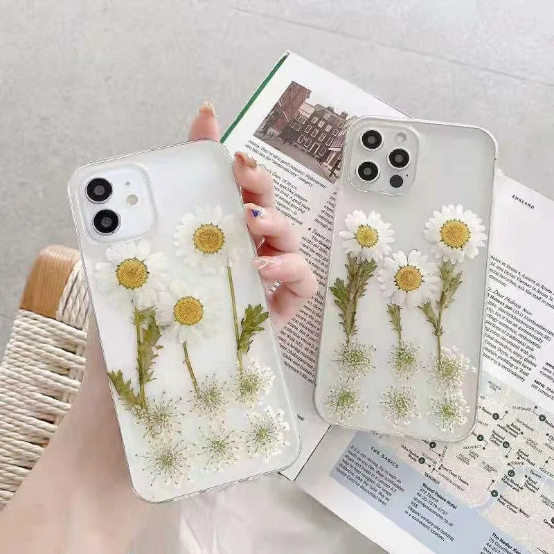White epoxy daisy floral design on a clear TPU protective phone case for iPhone.