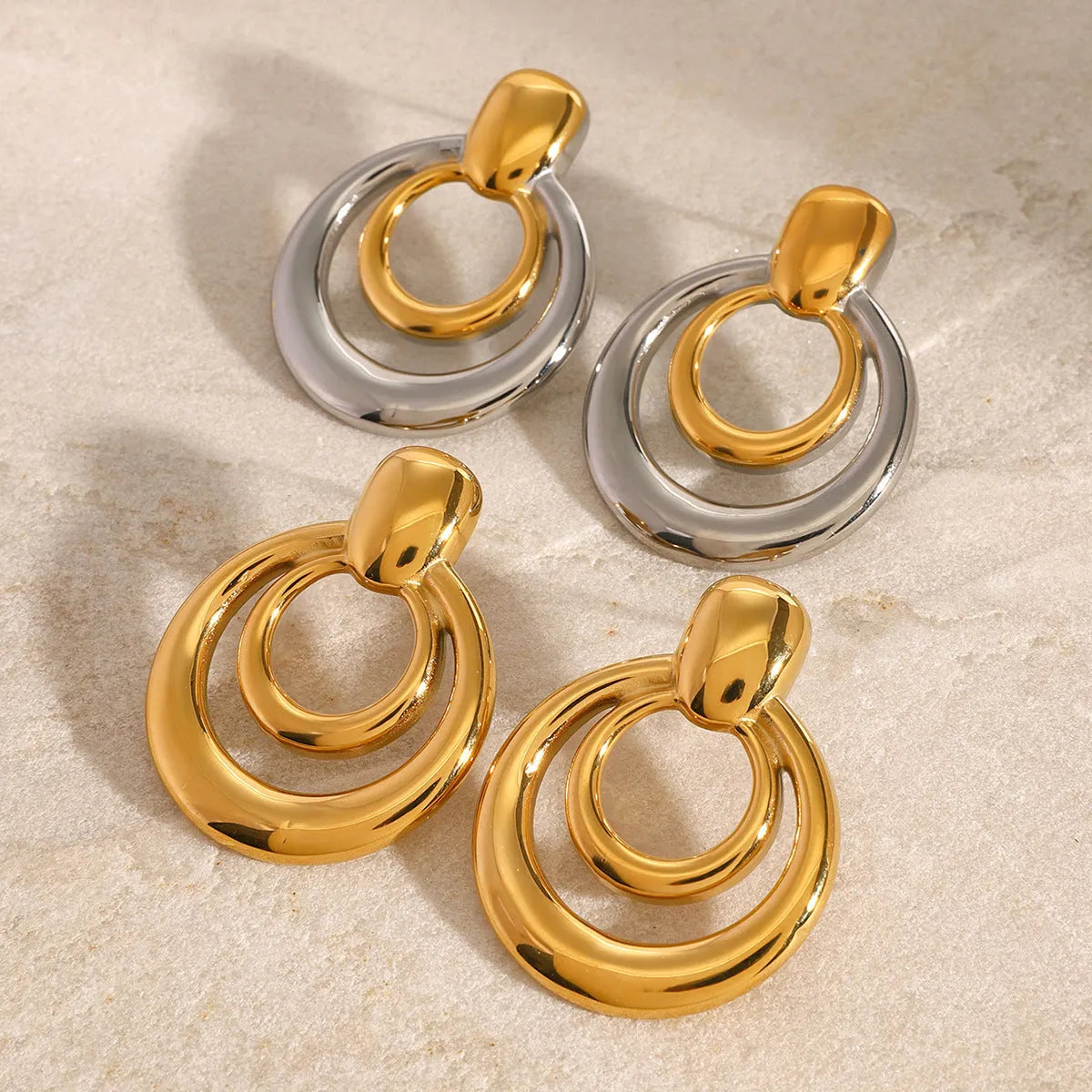 Gold geometric titanium steel stud earrings with double layer hollow round design