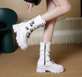 Women's black mid-calf boots with round toe, side zip, and adjustable metal buckle strap.
