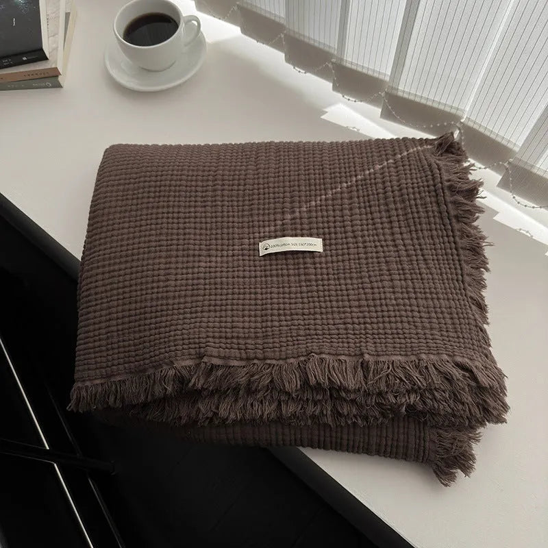 Four-layer gauze cotton blanket with edge tassels in a choice of ten colours and two sizes.