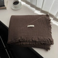 Four-layer gauze cotton blanket with edge tassels in a choice of ten colours and two sizes.