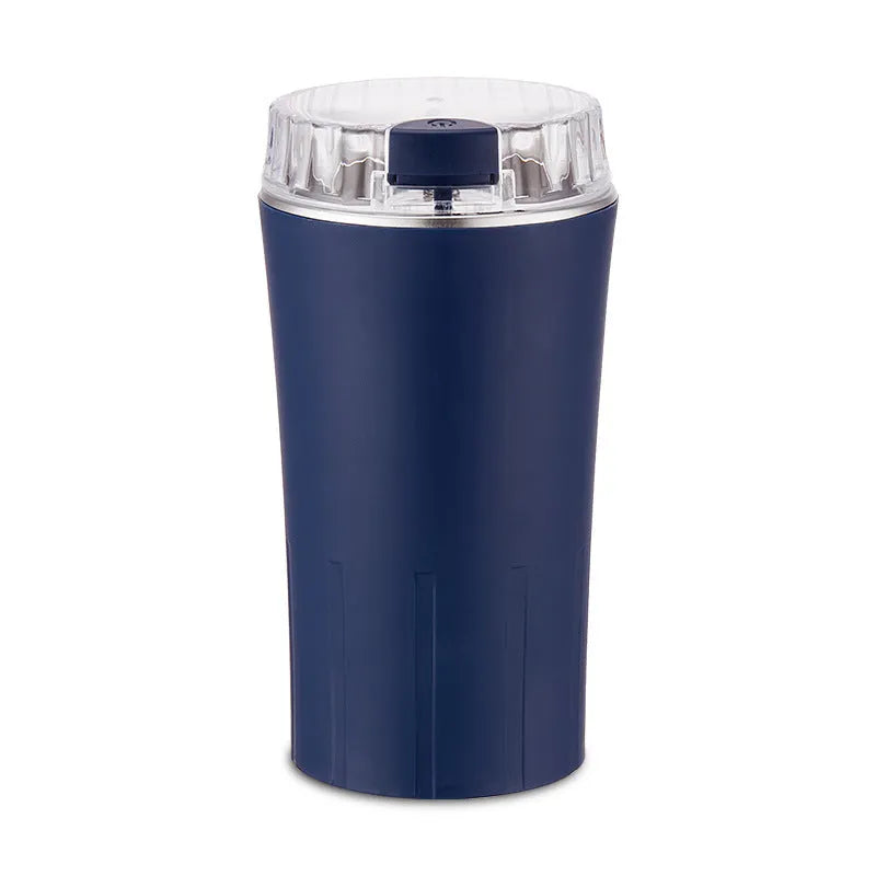Blue mini food grinder and flour mill with stainless steel construction on a kitchen countertop.