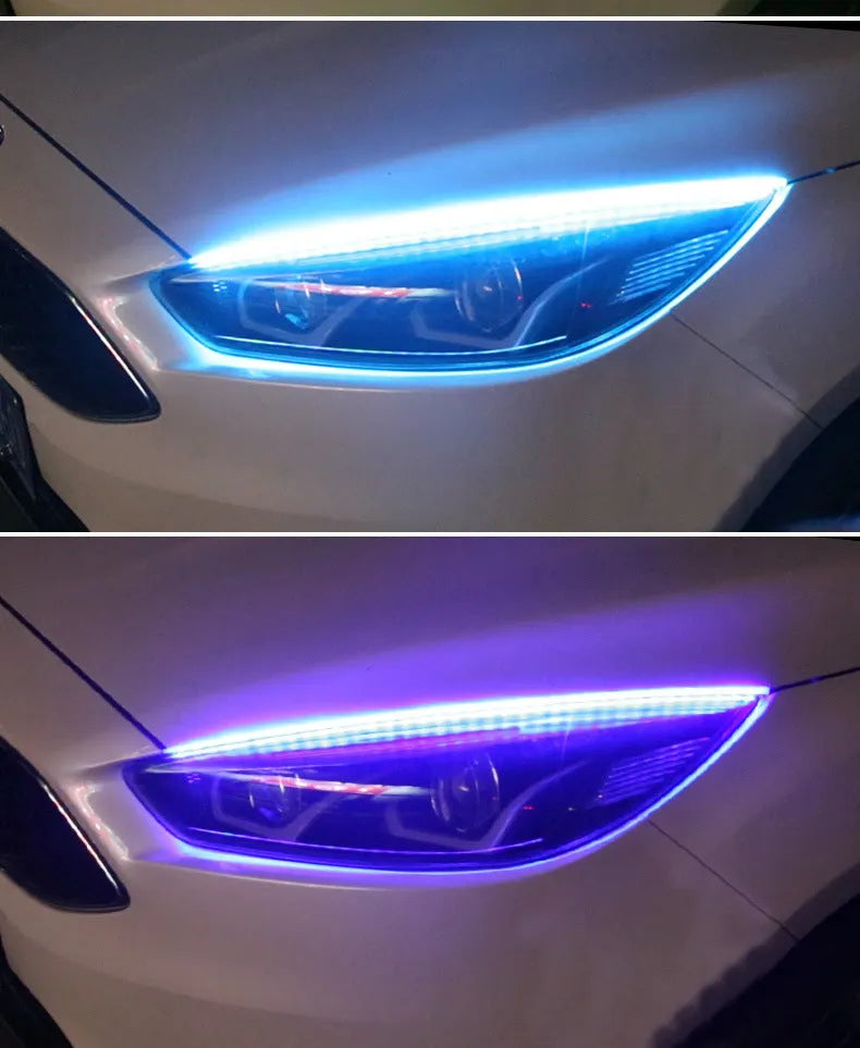 Close-up of a multi-colour RGB LED daytime running light strip with a remote control on a car bumper.