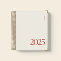 Cherry red daily schedule coil notebook open showing wire binding and printed schedule pages