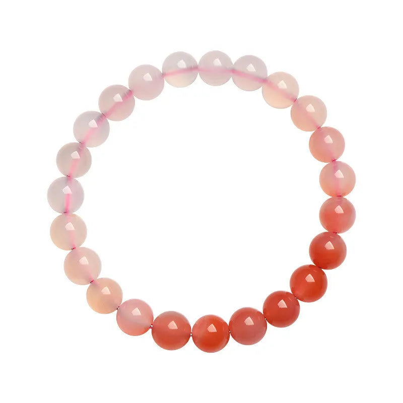 Natural gradient Yanyuan agate bracelet with geometric beads on a wrist.