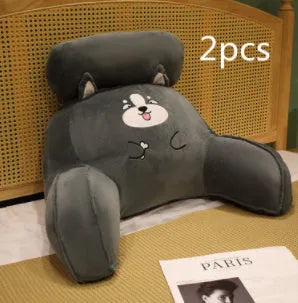 Triangle-shaped fluffy reading cushion on a chair, showing embroidered husky design and detachable cover.
