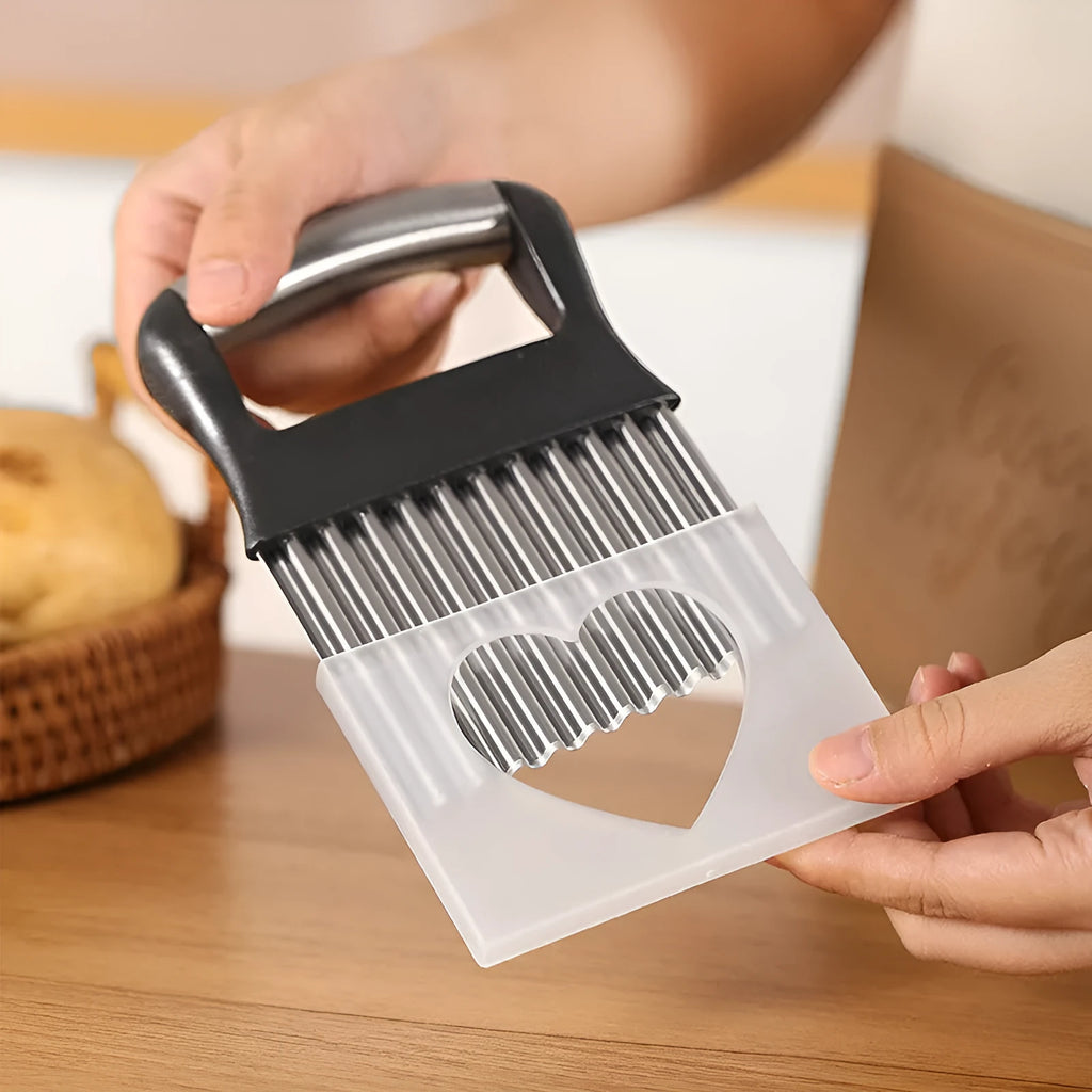 A black stainless steel potato wave knife on a kitchen counter, showing its corrugated blade.