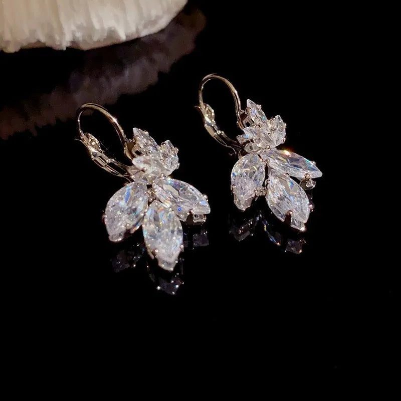 Platinum colour alloy earrings with leaves shape design featuring inlaid zircon stones
