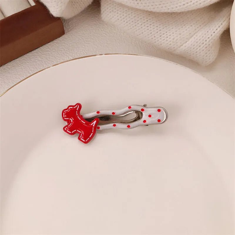 Red love heart-shaped hair clip with white polka dots and a green willow leaf decoration.