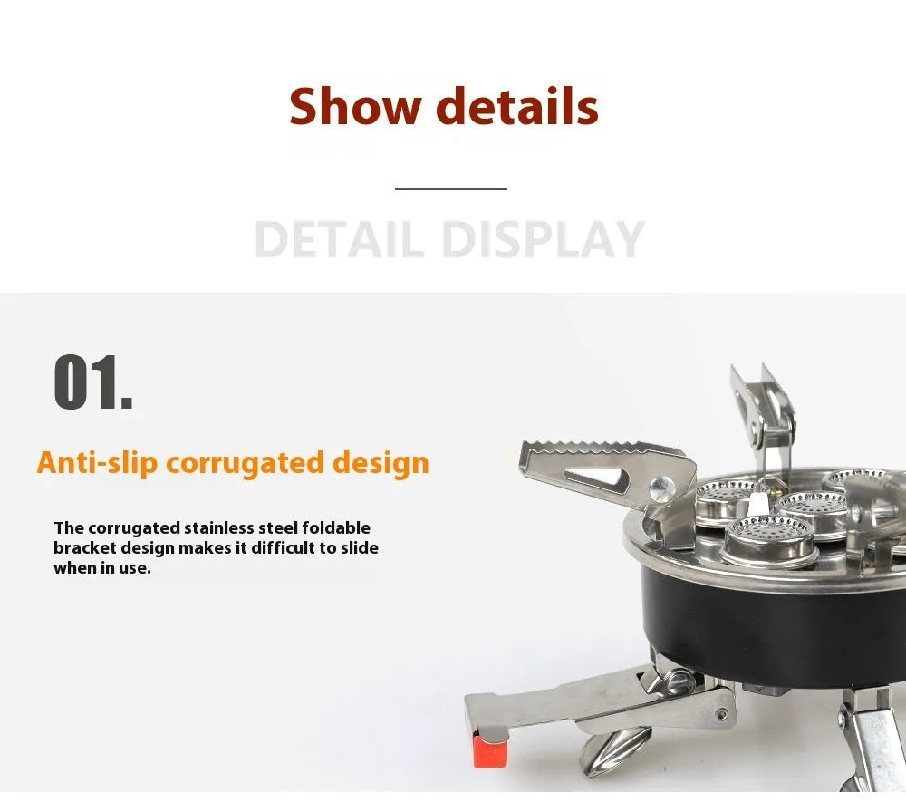 Silver portable split camping stove with foldable legs and a long black hose, on a grass background.