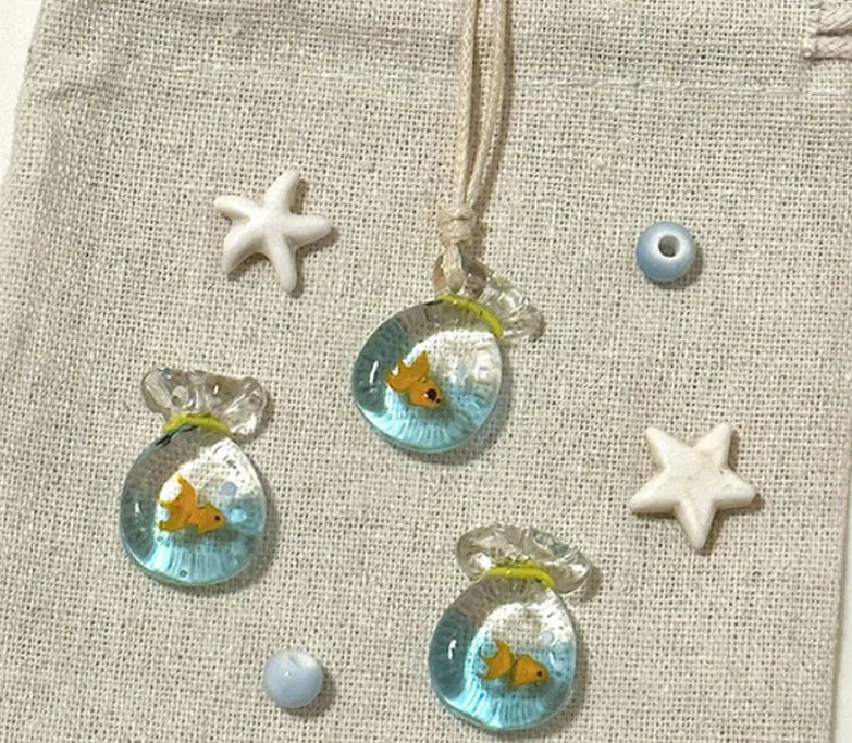 Women's world style necklace with coloured glaze joker pendant on a cotton linen clavicle chain.