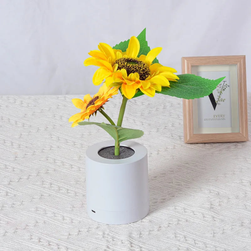 Sunflower LED night light with artificial flowers on wooden table