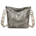 Soft grey PU crossbody bag with a large main compartment and adjustable shoulder strap