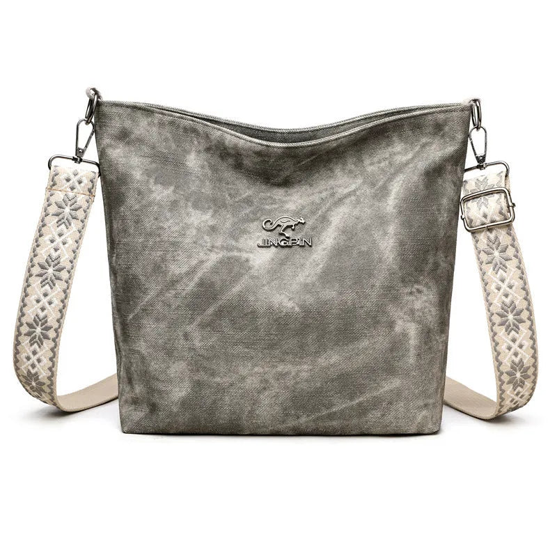 Soft grey PU crossbody bag with a large main compartment and adjustable shoulder strap