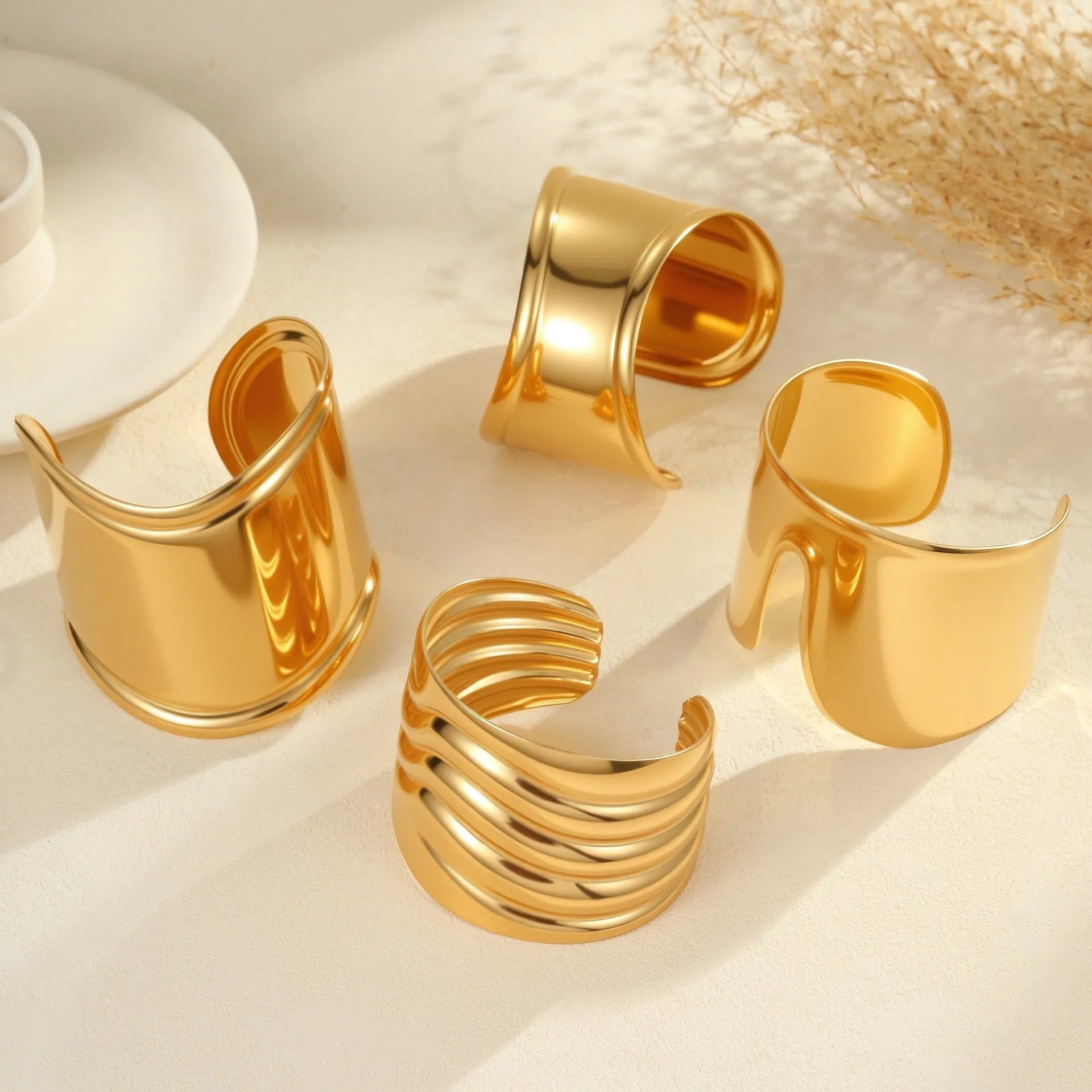 Women's gold plated stainless steel bracelet with wide geometric wave design and niche opening