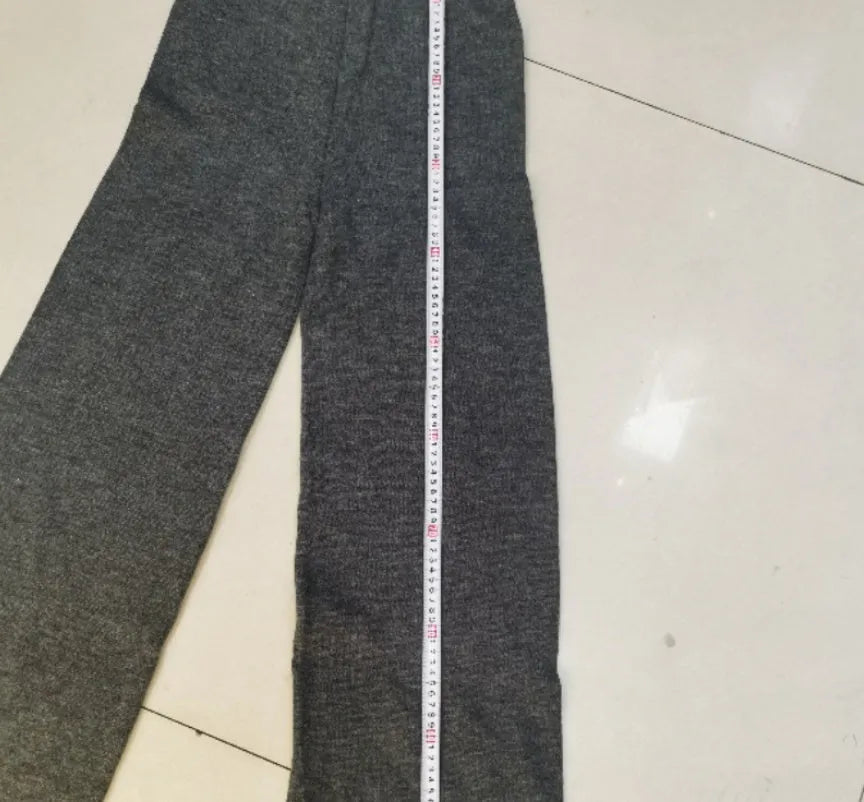 Women's dark grey acrylic suit featuring a side-slit sweater with matching full-length trousers.