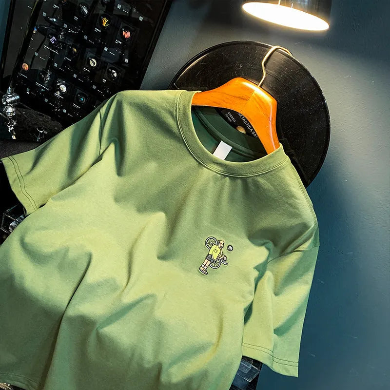 Green men's loose fit t-shirt with a printed design and short sleeves.
