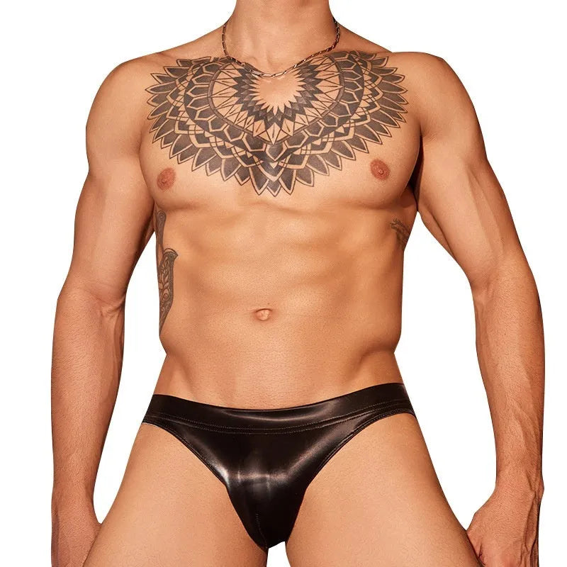 Black men's briefs made from shark skin lace polyester fabric, showing the textured material and small hip style cut.