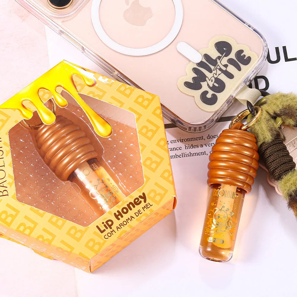 Honey lip gloss keychain with portable pannier bag carrier showing moisturising lip product