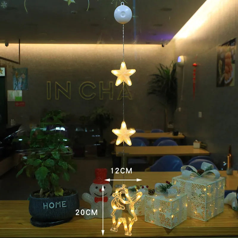 Set of three battery-powered LED Christmas pendant lights with suction cups, showing star, tree, and deer designs.