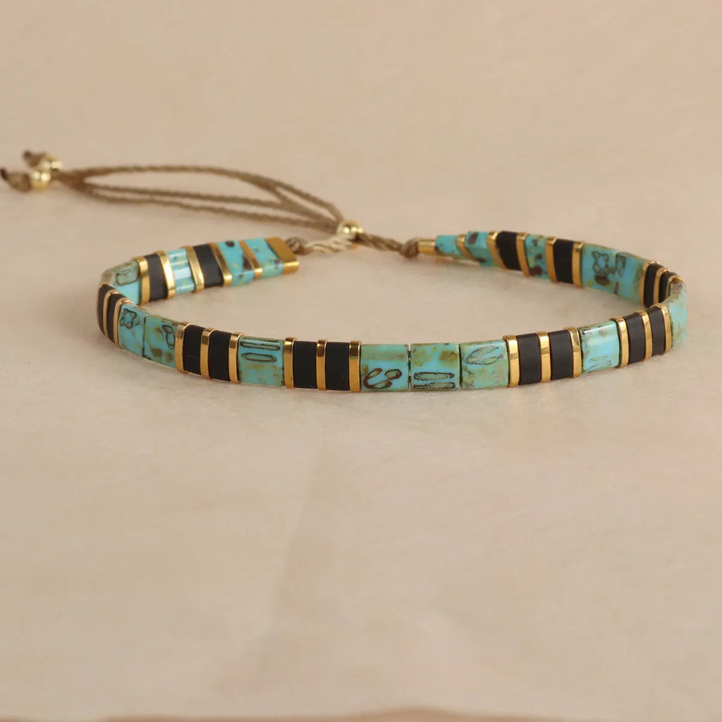 Geometric glass bead bracelet in milky white, black, retro green, light blue, or red colours.