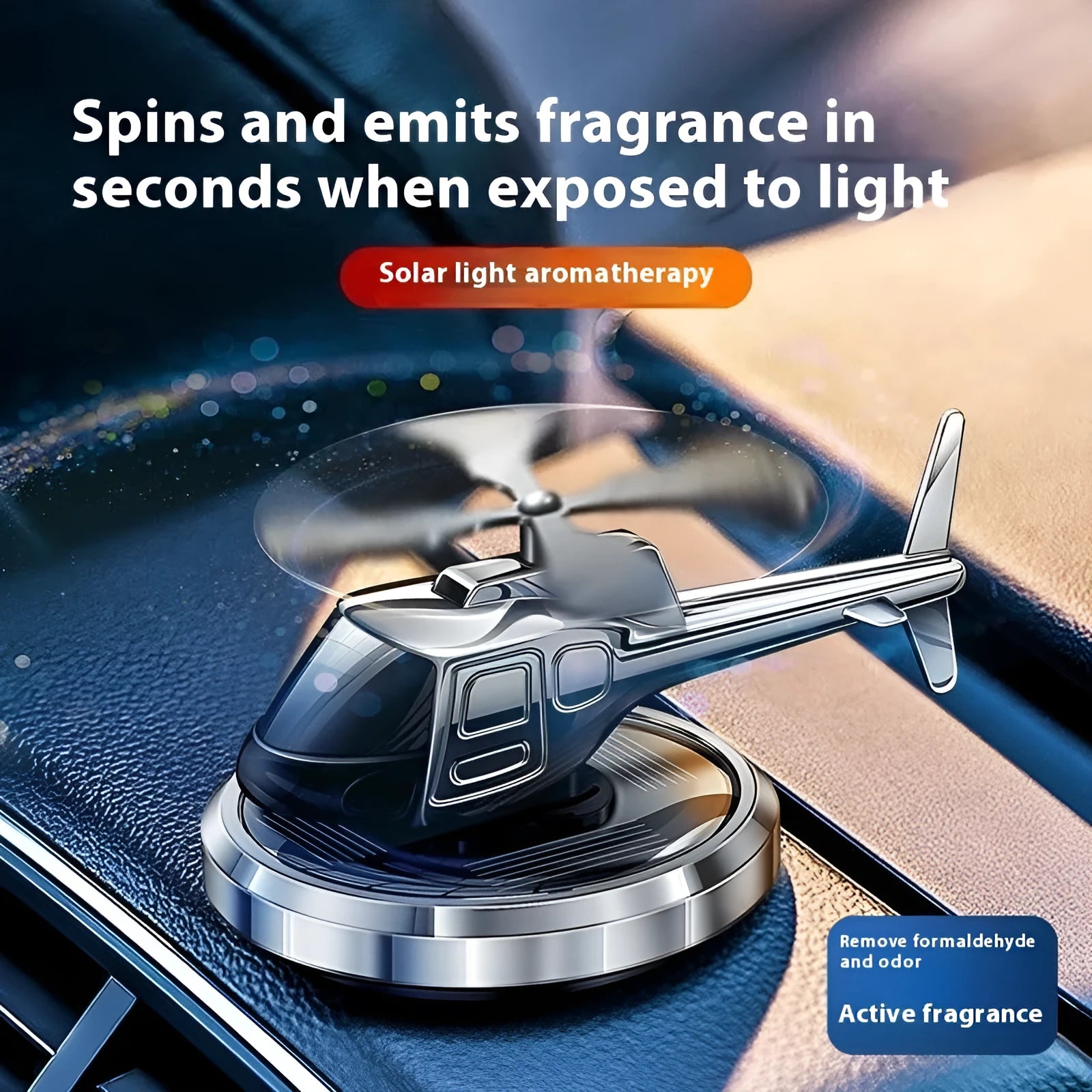 Silver solar-powered metal helicopter car air freshener with rotating blades on a dashboard.
