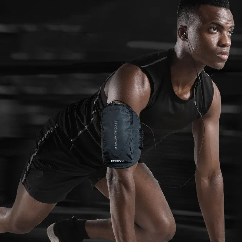 Black reflective running arm band wrapped around an arm, showing its strap and phone compartment.