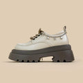 White platform leather shoes with chunky heel and front lace-up in Mary Jane style.