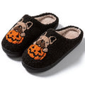 Black and white Halloween plush slippers with pumpkin design and non-slip rubber soles