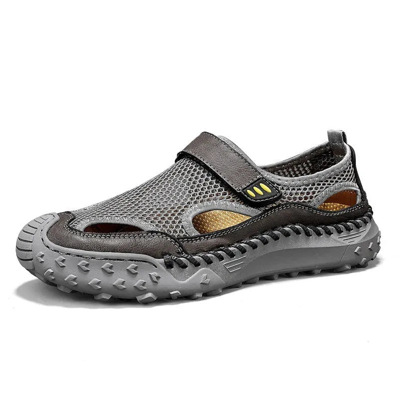 Men's black casual sandals with mesh upper and Velcro strap on a rubber sole.