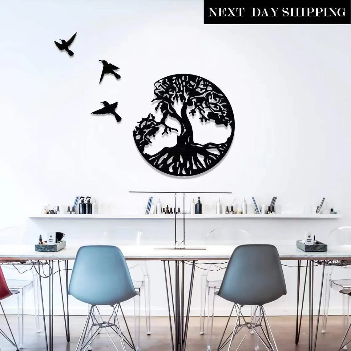 Black decorative iron wind chime wall art with a modern simple design, shown with its hanging strap.