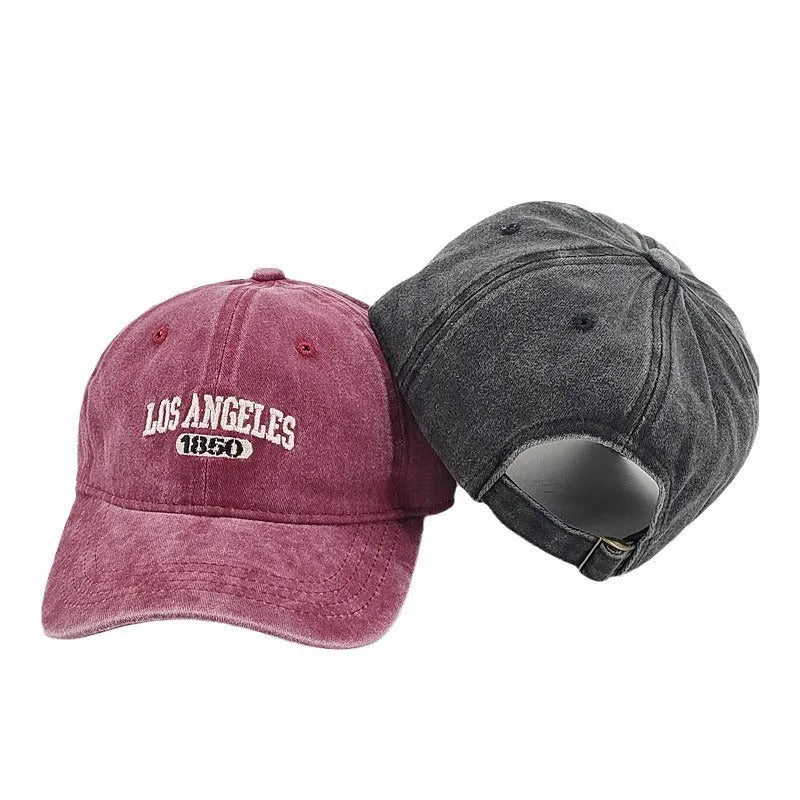 Retro distressed baseball cap with embroidered letters on the front, shown in a beige colour.