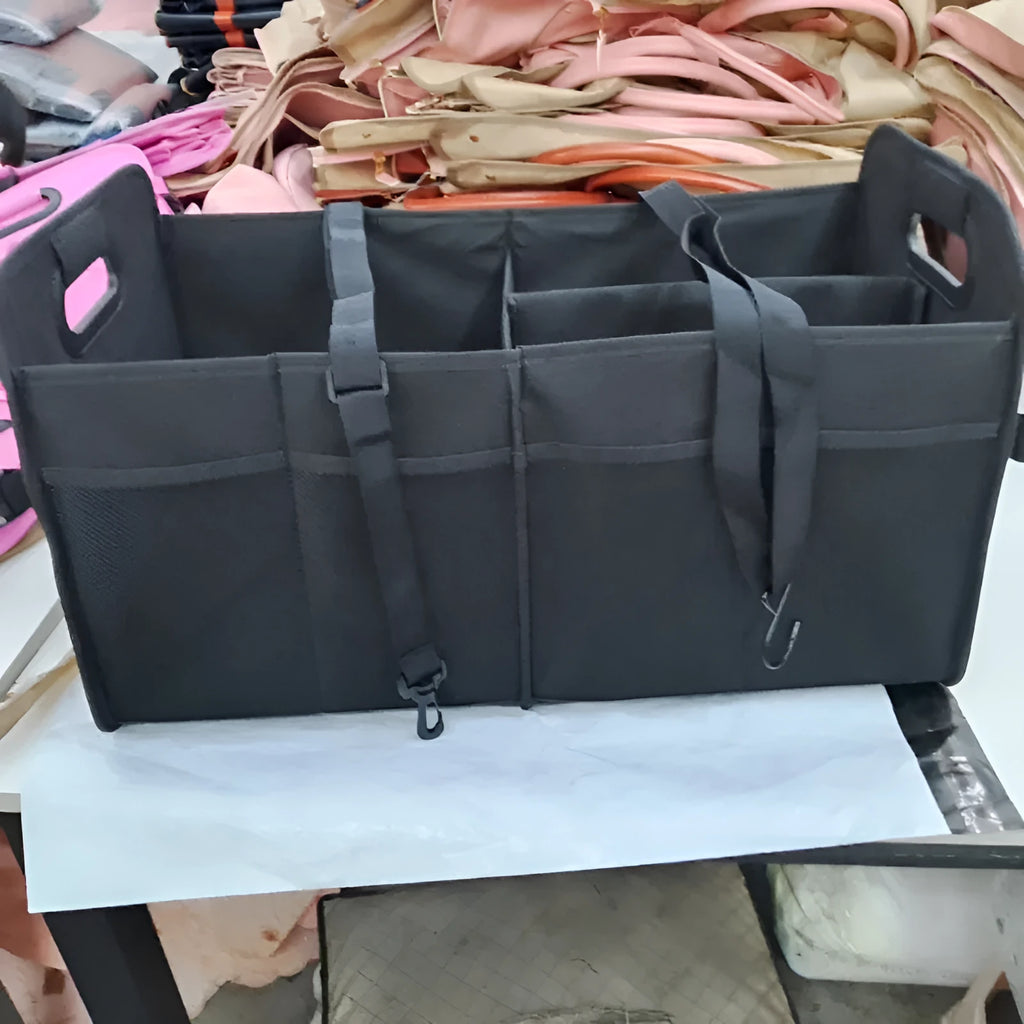 Black foldable fabric car trunk storage box with handles, shown with multiple compartments.