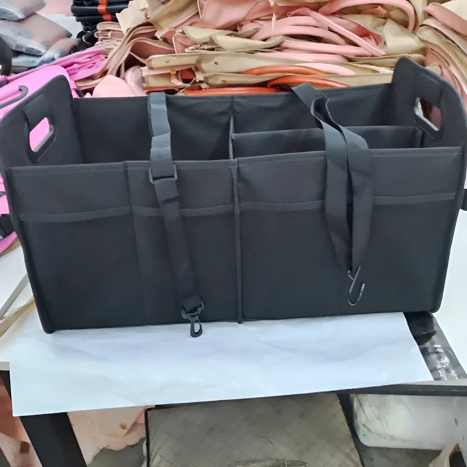 Black foldable fabric car trunk storage box with handles, shown with multiple compartments.