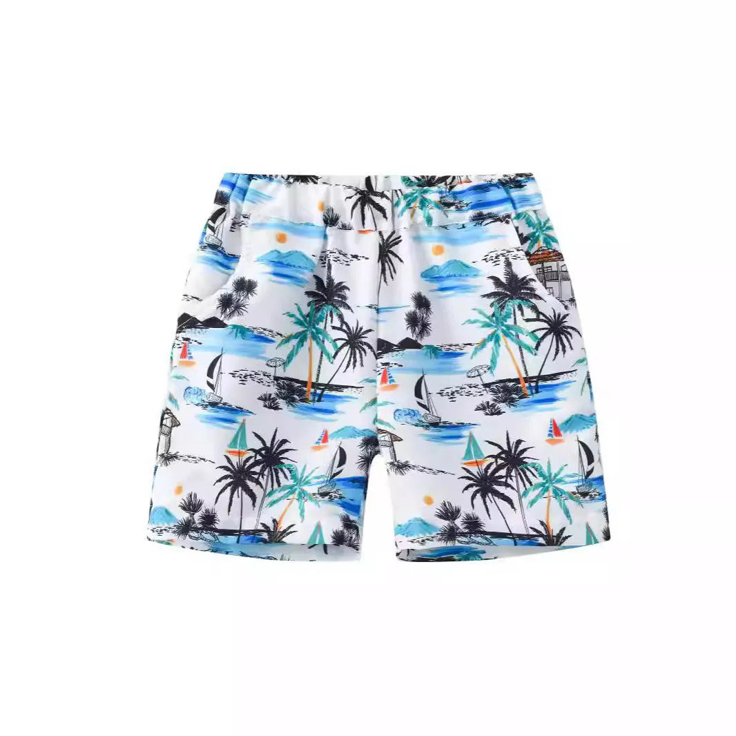 Colourful printed beach shorts on a hanger showing coconut tree and dinosaur designs.