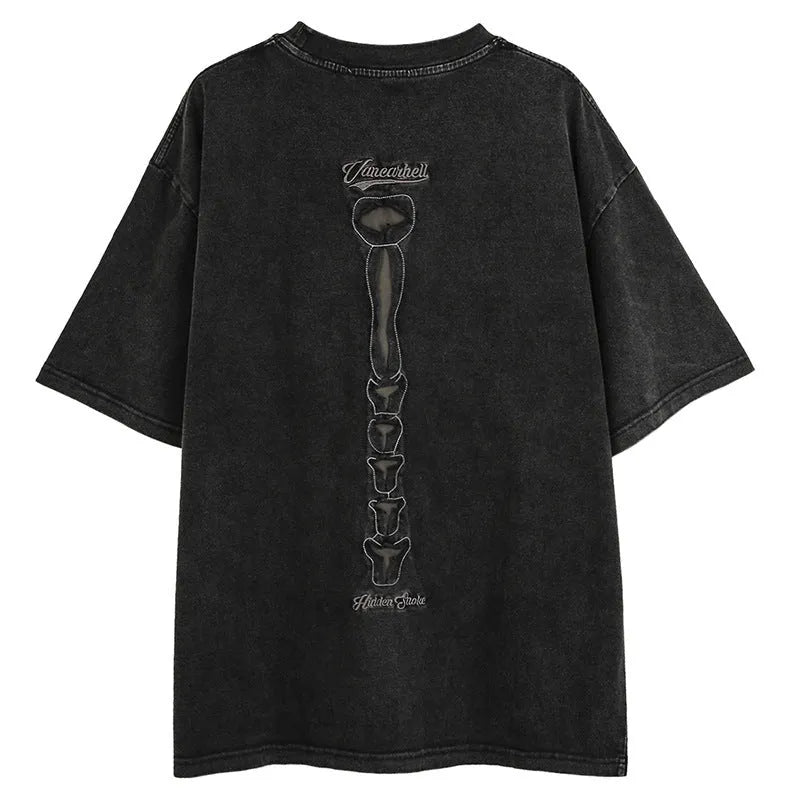 Man modelling a brown loose-fit cotton T-shirt with a printed skull graphic on the front.
