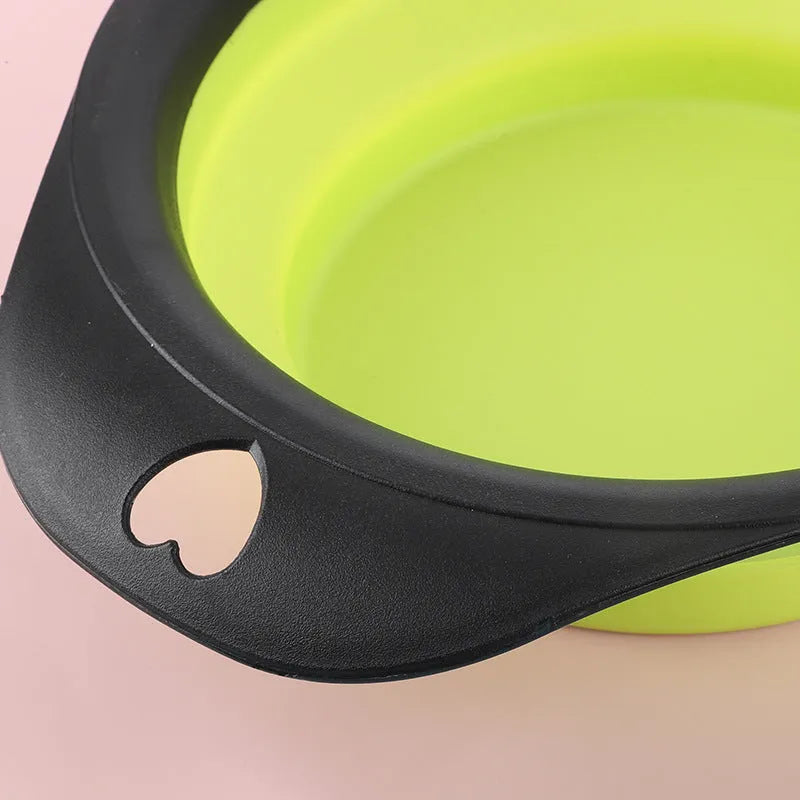Black silicone pet bowl shown both folded flat and snapped open, next to a dog leash.