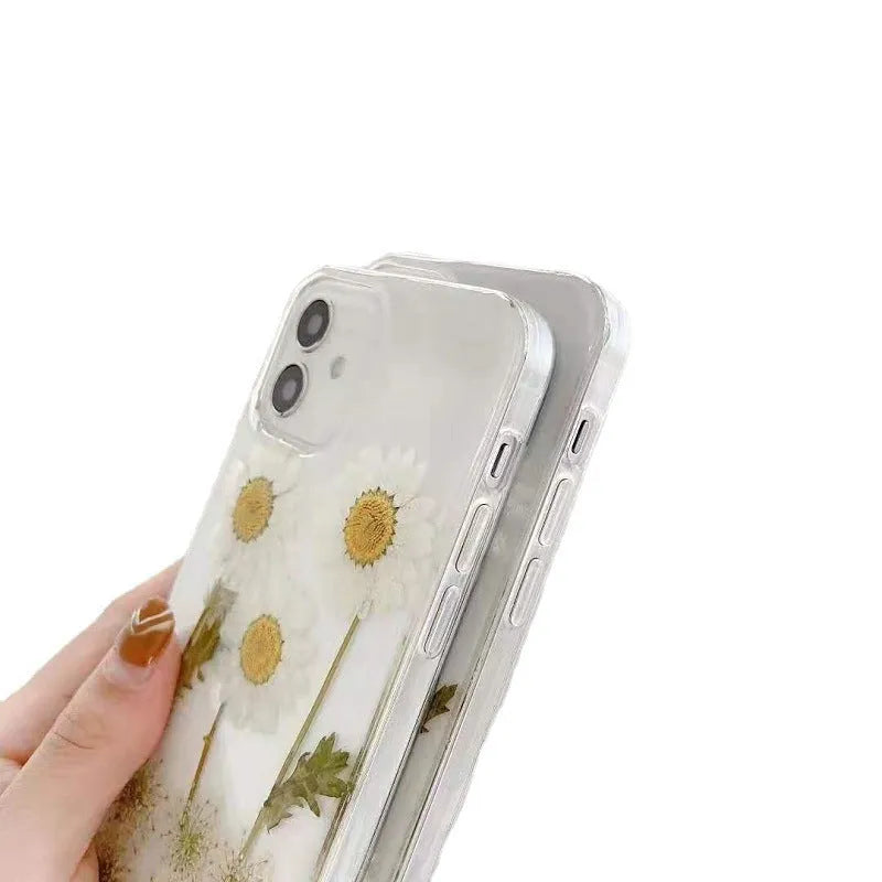 White epoxy daisy floral design on a clear TPU protective phone case for iPhone.