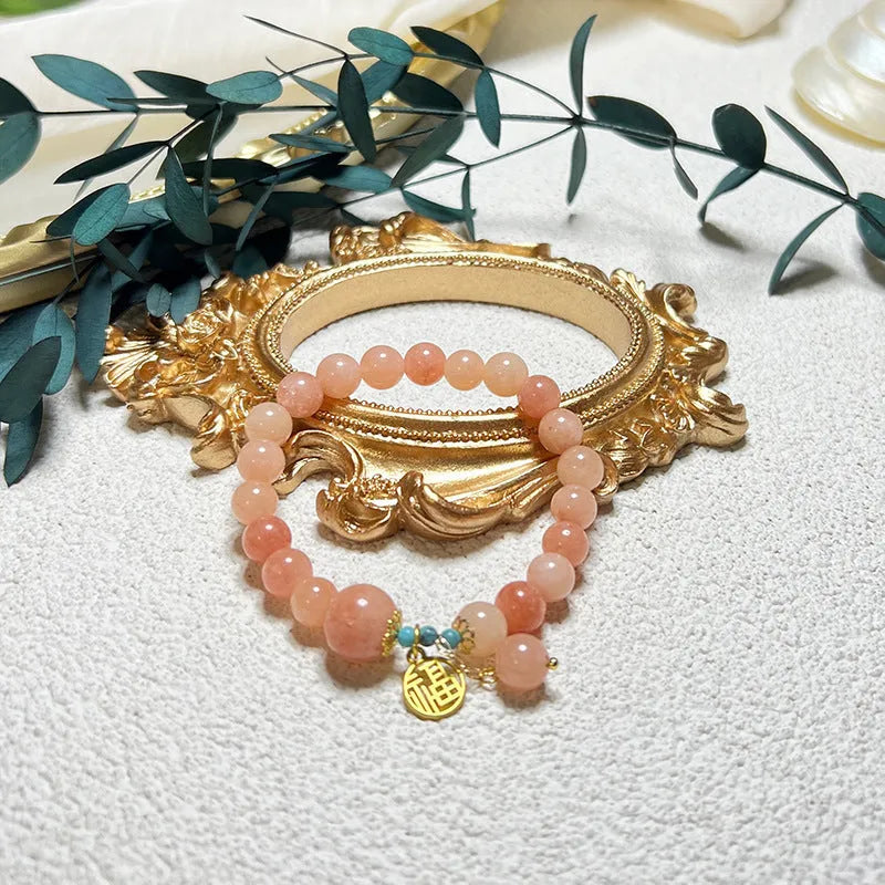 Pink natural stone set on a simple alloy chain bracelet for women.