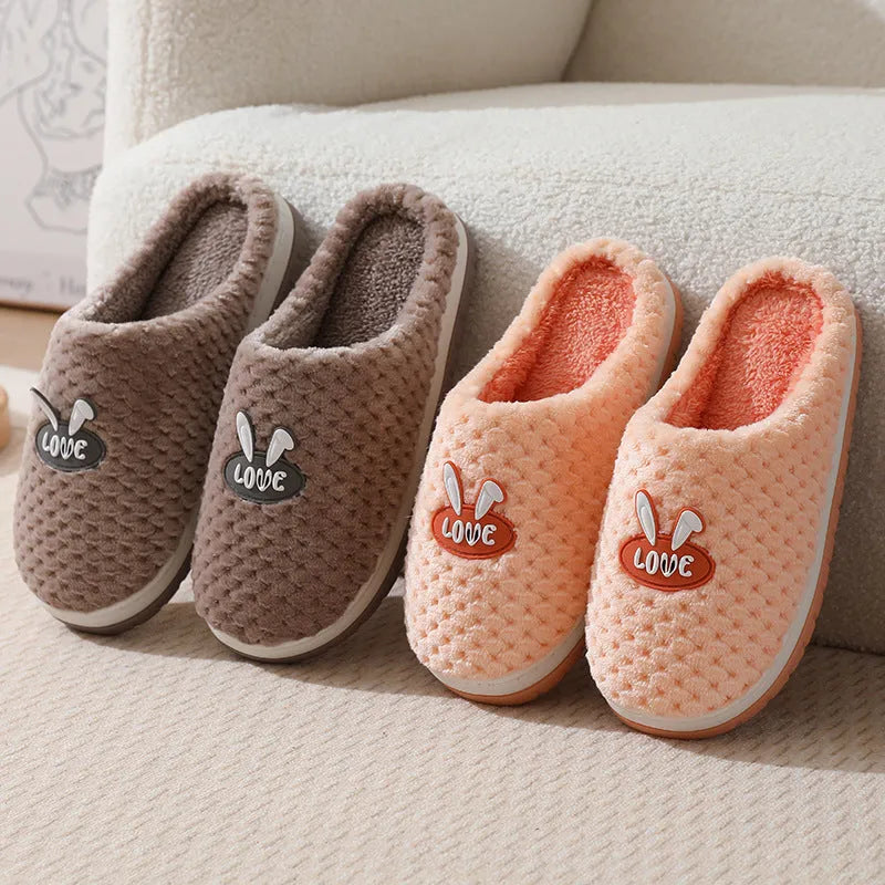 Women's plaid design house slippers with artificial fur upper and thick rubber sole in various colours.