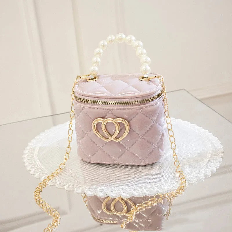 Women's PVC bucket gel bag with heart-shaped pattern in assorted colours.