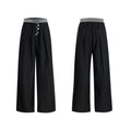Black high-waisted straight-leg casual trousers featuring a button-open line design detail on the leg.