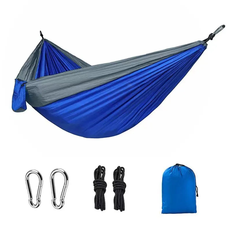 Blue nylon parachute cloth camping hammock hung between trees.