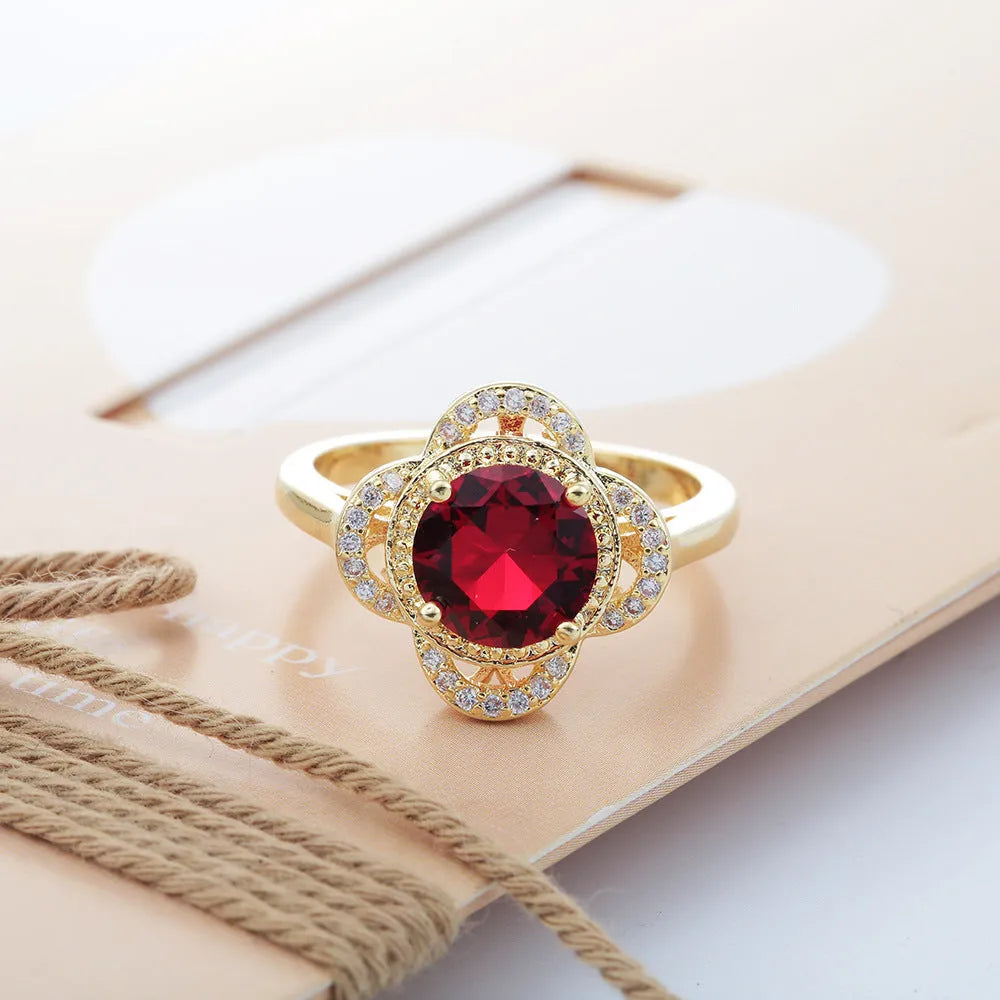 Copper fruit-shaped ring with a zircon stone, showing electroplated finish.