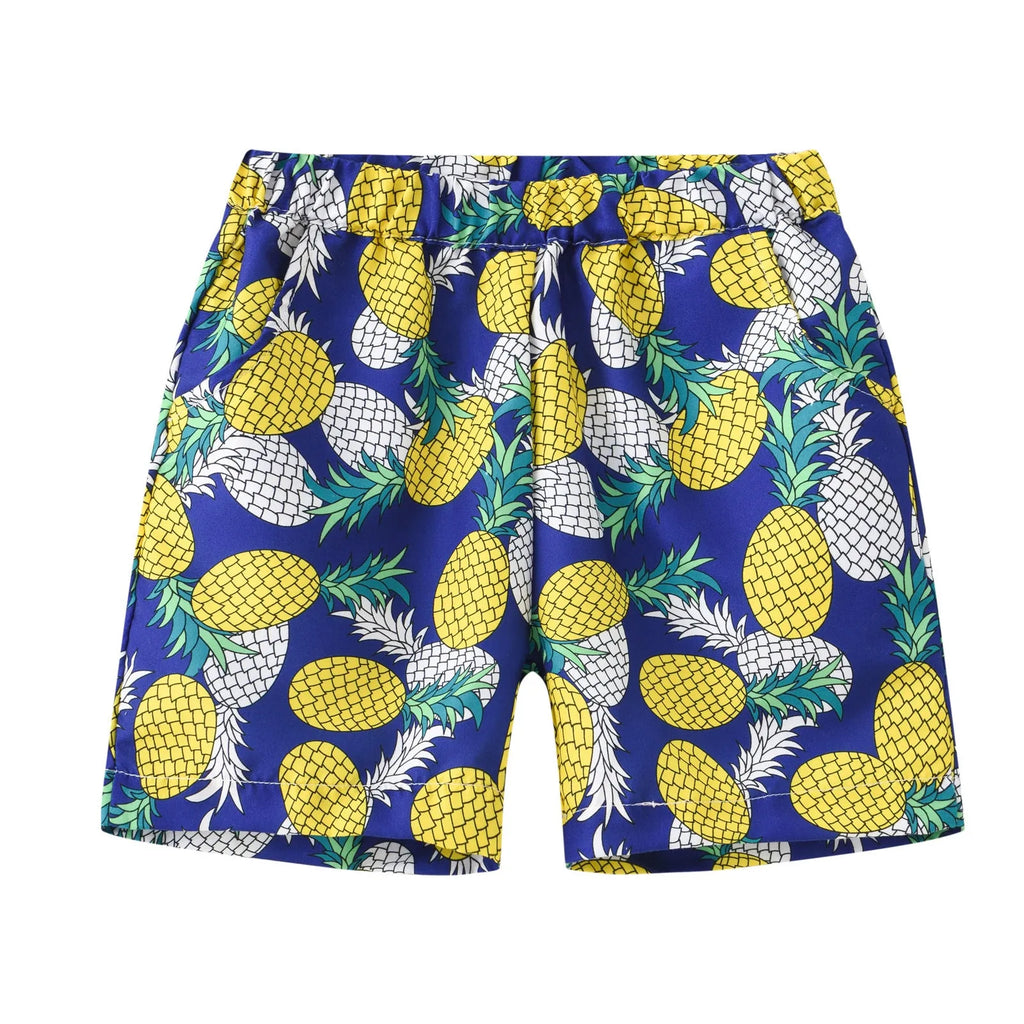 Colourful printed beach shorts on a hanger showing coconut tree and dinosaur designs.