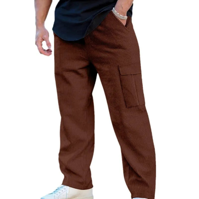 Men's navy blue corduroy cargo trousers with a straight loose leg and a drawstring waist, laid flat.